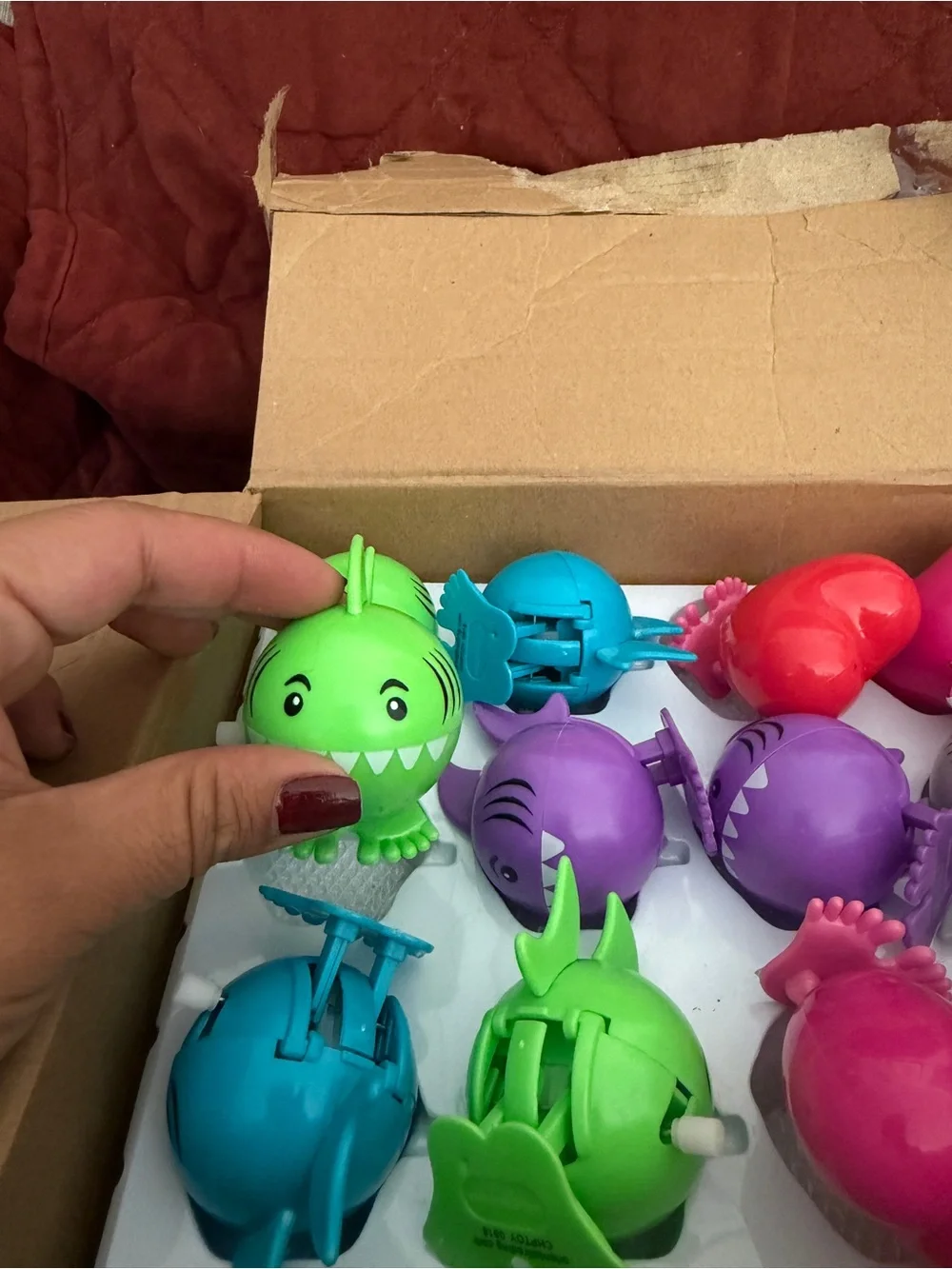 Assorted colors of sharks and hearts wind up toys .